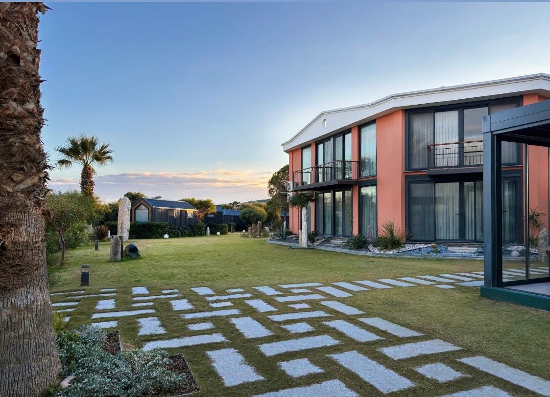 Silver Bay Club House garden and coastal accommodation